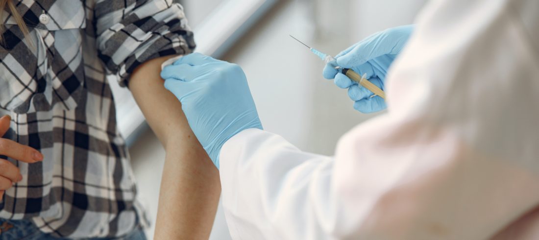 doctor giving a shot to patient in the arm