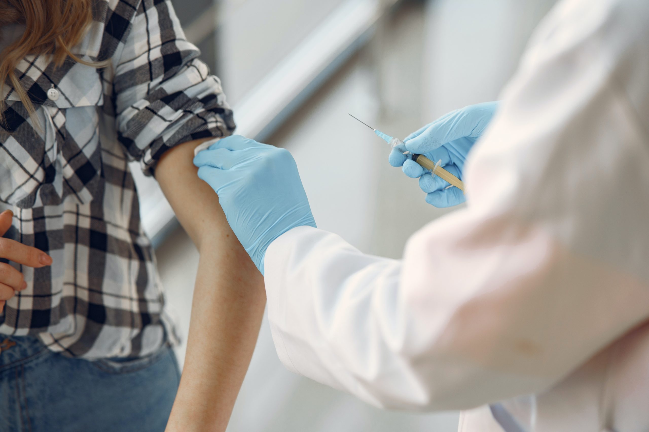 doctor giving a shot to patient in the arm