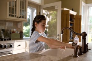 young girl washing hands